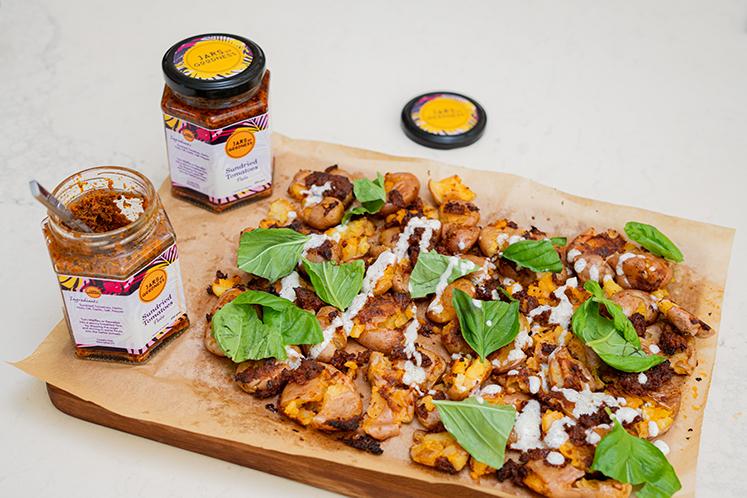 Crispy Smashed Potatoes with Sundried Tomato Pesto and Sour Cream Drizzle